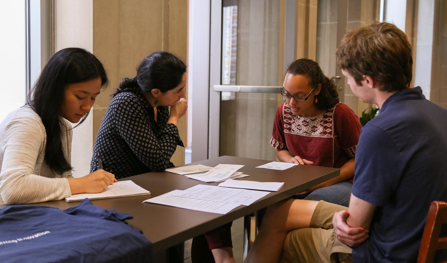 four people sitting around a table
