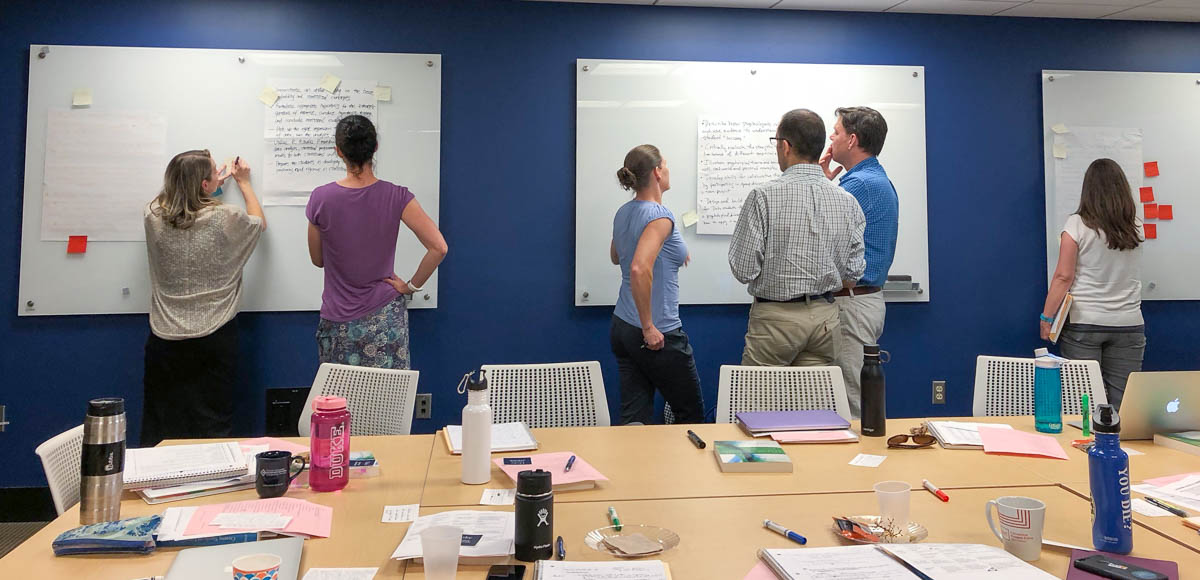 course design institute participants working at white boards