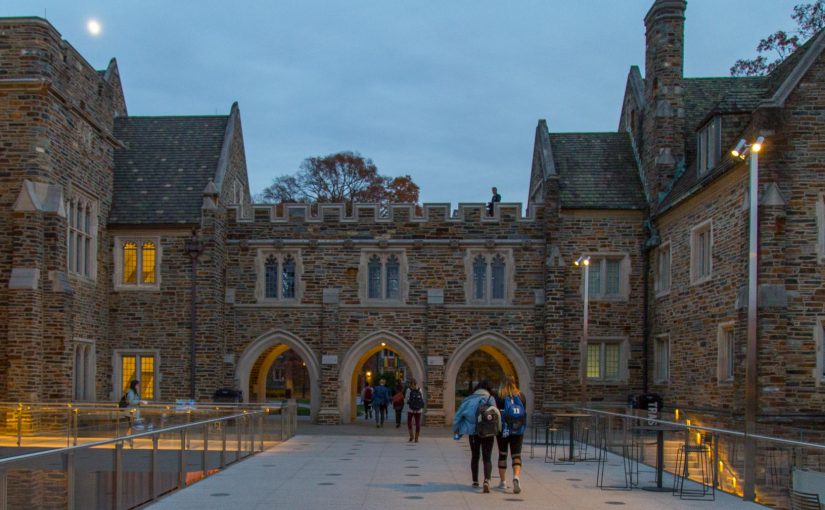 students walking through west campus at dusk