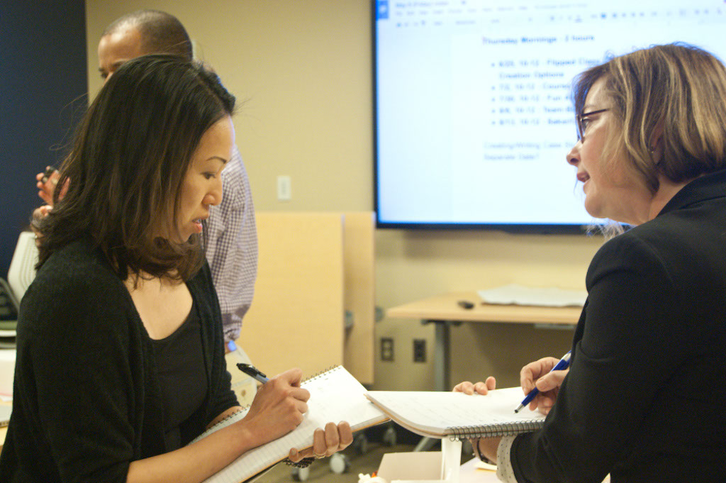 Minna Ng and Gennifer Weisenfeld discuss an activity during the 2015 CIT faculty fellowship