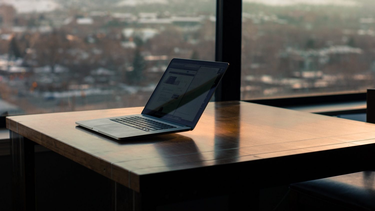 laptop next to window