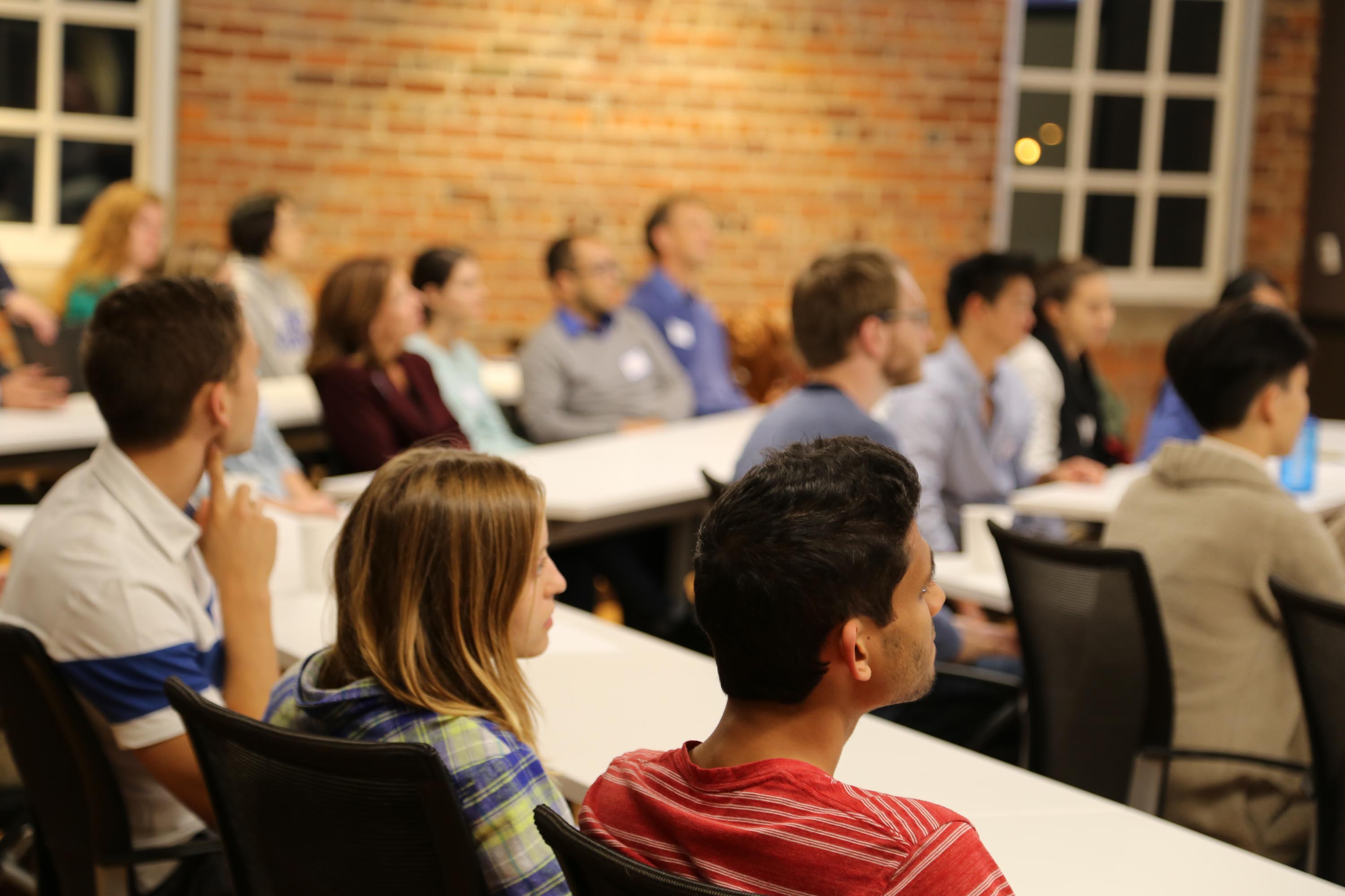 people listening to a presentation in a classroom