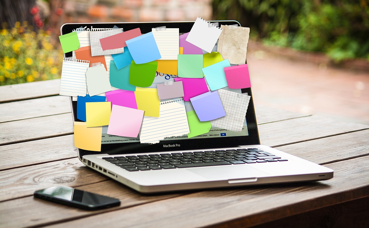 laptop covered with sticky notes