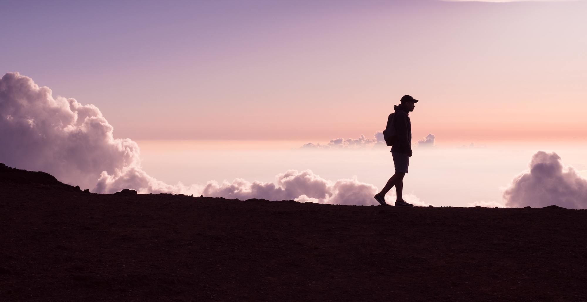 young man hiking on a ridge