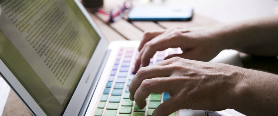 person typing on computer keyboard