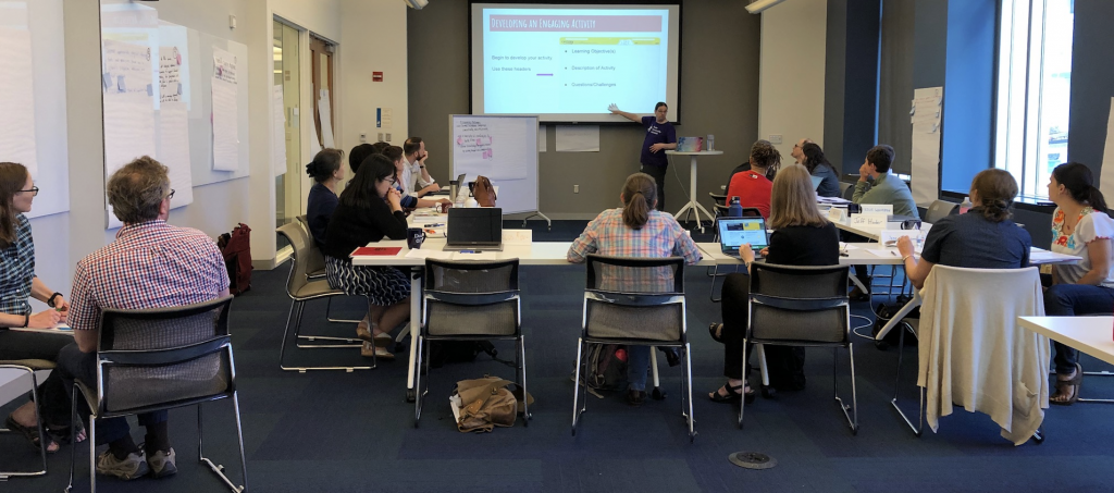 People in a room watching a presentation