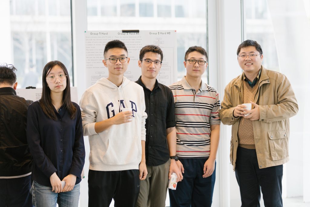 students and instructor standing in a classroom